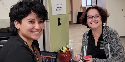 two employees smiling