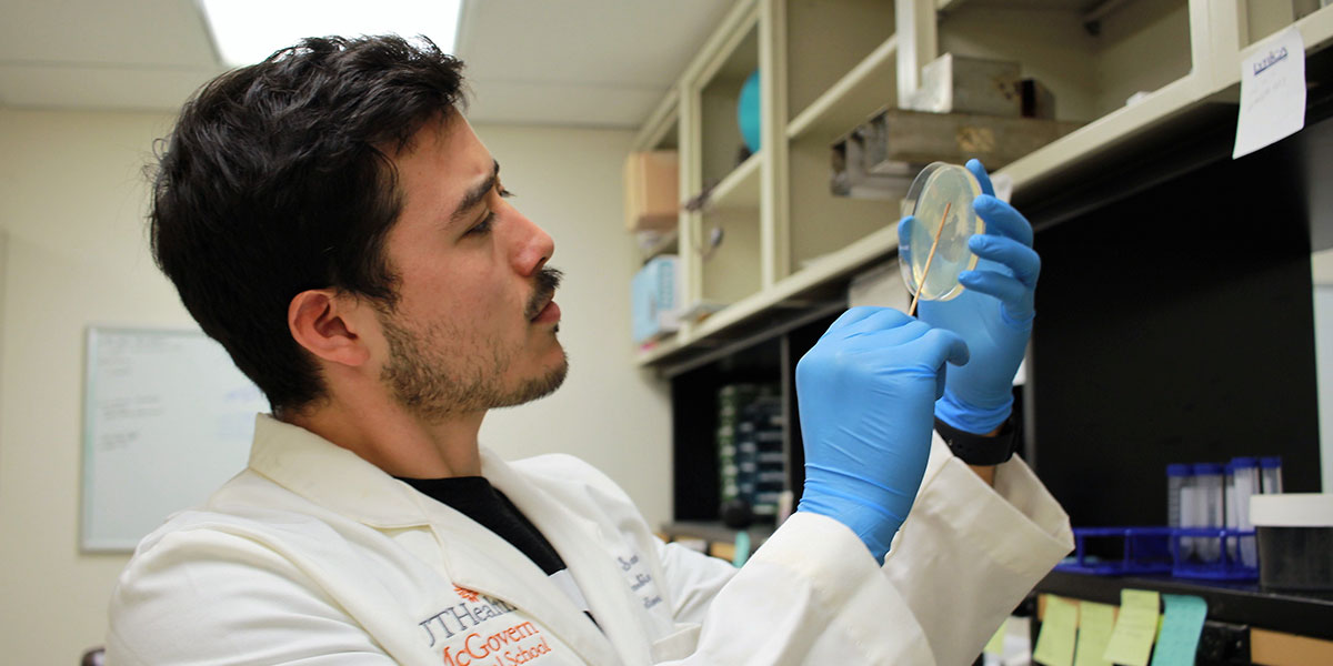 researcher with petri dish